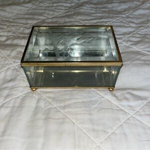 Vintage glass jewelry or trinket box with gold trim.